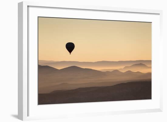 Single Hot Air Balloon over a Misty Dawn Sky, Cappadocia, Anatolia, Turkey, Asia Minor, Eurasia-David Clapp-Framed Photographic Print