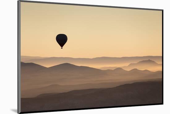 Single Hot Air Balloon over a Misty Dawn Sky, Cappadocia, Anatolia, Turkey, Asia Minor, Eurasia-David Clapp-Mounted Photographic Print