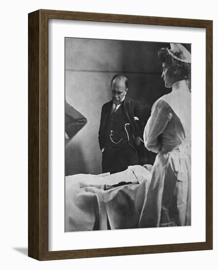 Sir William Osler Reading a Patient's Chart at Bedside as a Nurse Watches, Ca. 1903-null-Framed Photo