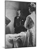 Sir William Osler Reading a Patient's Chart at Bedside as a Nurse Watches, Ca. 1903-null-Mounted Photo