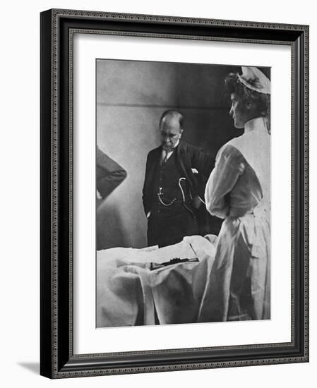 Sir William Osler Reading a Patient's Chart at Bedside as a Nurse Watches, Ca. 1903-null-Framed Photo