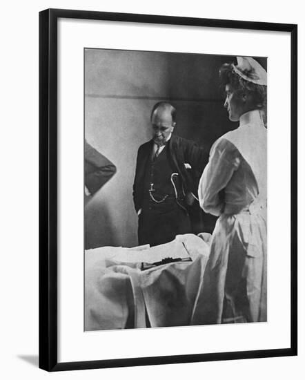 Sir William Osler Reading a Patient's Chart at Bedside as a Nurse Watches, Ca. 1903-null-Framed Photo