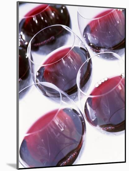 Six Glasses of Red Wine Against White Background-Linda Burgess-Mounted Photographic Print