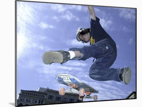 Skateboarder in Midair Doing a Trick-null-Mounted Photographic Print