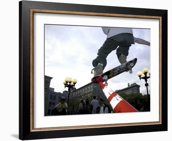 Skateboarder in Midair Knocking Over a Cone-null-Framed Photographic Print