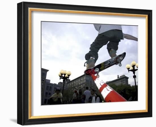 Skateboarder in Midair Knocking Over a Cone-null-Framed Photographic Print