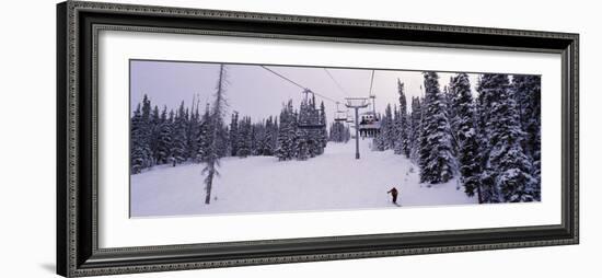 Ski Lift Passing over a Snow Covered Landscape, Keystone Resort, Keystone, Colorado, USA-null-Framed Photographic Print