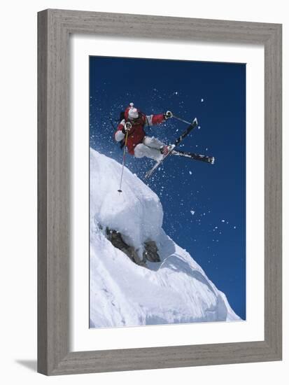 Skier in Mid-Air Above Snow on Ski Slopes-null-Framed Photo