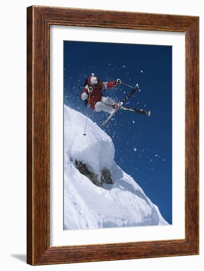 Skier in Mid-Air Above Snow on Ski Slopes-null-Framed Photo