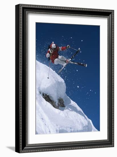 Skier in Mid-Air Above Snow on Ski Slopes-null-Framed Photo