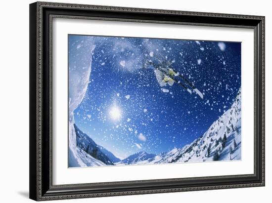 Skier Jumping from Mountain Ledge-null-Framed Photo