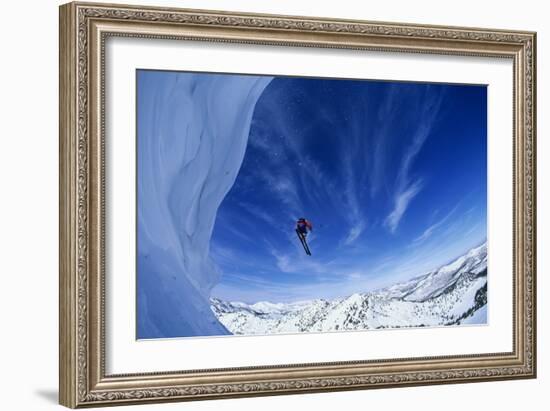 Skier Jumping from Mountain Ledge-null-Framed Photo