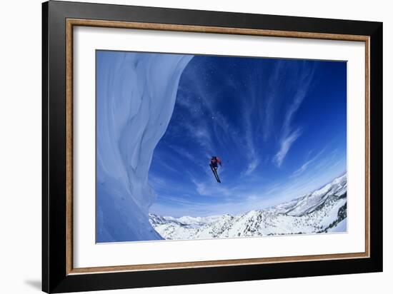 Skier Jumping from Mountain Ledge-null-Framed Photo