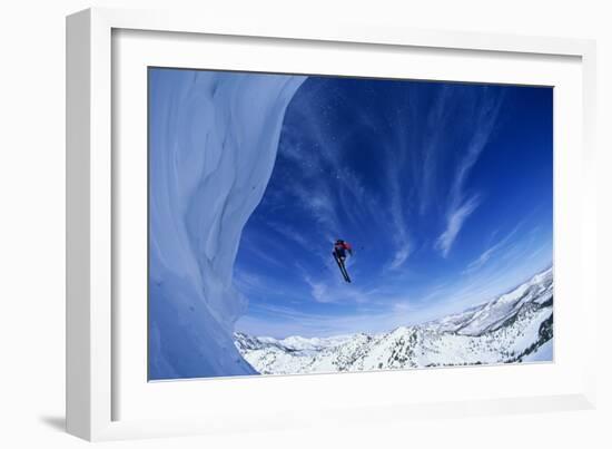 Skier Jumping from Mountain Ledge-null-Framed Photo