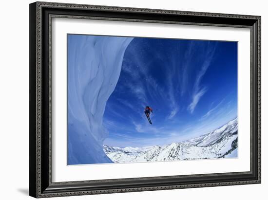 Skier Jumping from Mountain Ledge-null-Framed Photo