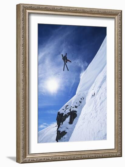 Skier Jumping from Mountain Ledge-null-Framed Photo