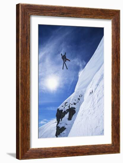 Skier Jumping from Mountain Ledge-null-Framed Photo