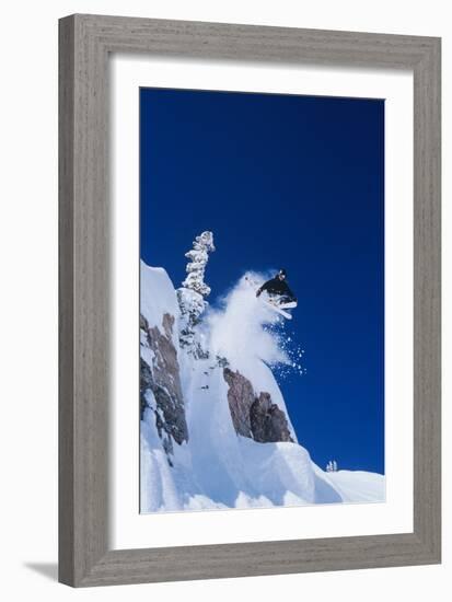 Skier Jumping from Mountain Ledge-null-Framed Photo