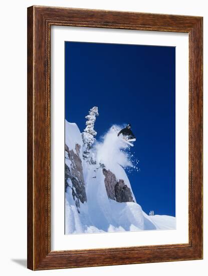 Skier Jumping from Mountain Ledge-null-Framed Photo