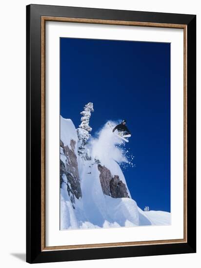 Skier Jumping from Mountain Ledge-null-Framed Photo