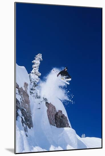 Skier Jumping from Mountain Ledge-null-Mounted Photo