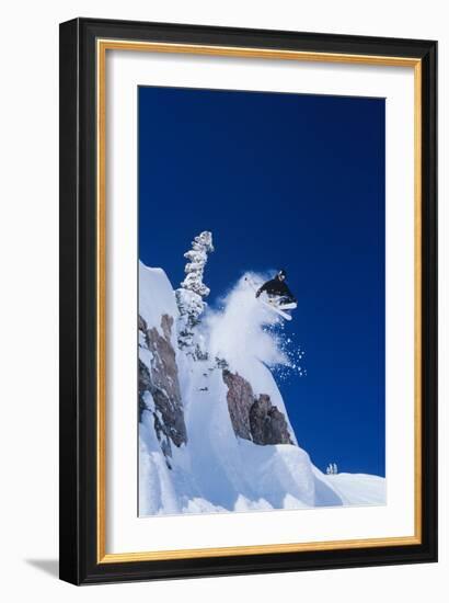 Skier Jumping from Mountain Ledge-null-Framed Photo