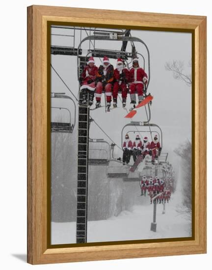 Skiers and Snowboarders Dressed as Santa Claus Ride up the Ski Lift-null-Framed Premier Image Canvas