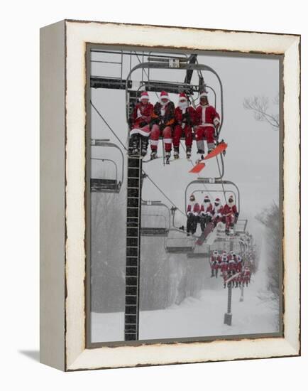 Skiers and Snowboarders Dressed as Santa Claus Ride up the Ski Lift-null-Framed Premier Image Canvas