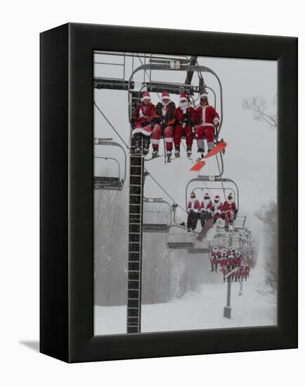 Skiers and Snowboarders Dressed as Santa Claus Ride up the Ski Lift-null-Framed Premier Image Canvas