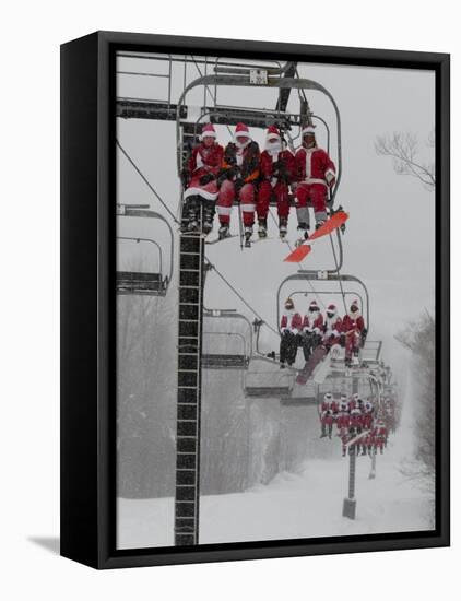 Skiers and Snowboarders Dressed as Santa Claus Ride up the Ski Lift-null-Framed Premier Image Canvas