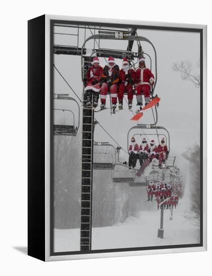 Skiers and Snowboarders Dressed as Santa Claus Ride up the Ski Lift-null-Framed Premier Image Canvas