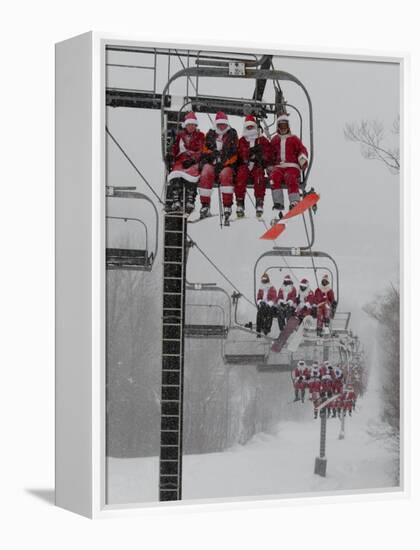 Skiers and Snowboarders Dressed as Santa Claus Ride up the Ski Lift-null-Framed Premier Image Canvas