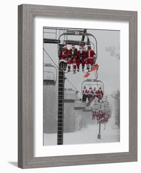 Skiers and Snowboarders Dressed as Santa Claus Ride up the Ski Lift-null-Framed Photographic Print