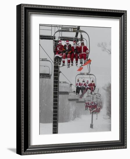 Skiers and Snowboarders Dressed as Santa Claus Ride up the Ski Lift-null-Framed Photographic Print