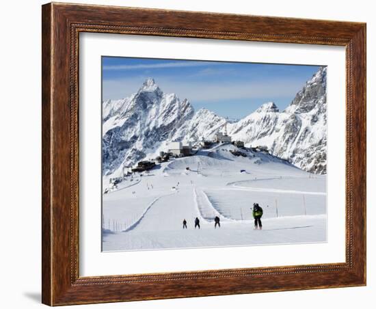 Skiers, Mountain Scenery in Cervinia Ski Resort, Cervinia, Valle D'Aosta, Italian Alps, Italy-Christian Kober-Framed Photographic Print