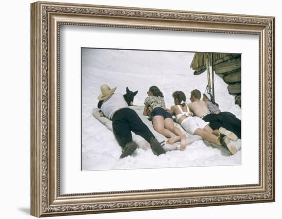 Skiers Sunbathing in Summer Fashions with Dog at Sun Valley Ski Resort, Idaho, April 22, 1947-George Silk-Framed Photographic Print