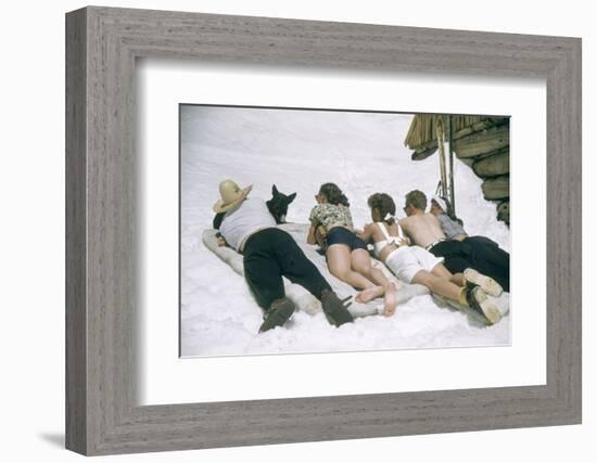 Skiers Sunbathing in Summer Fashions with Dog at Sun Valley Ski Resort, Idaho, April 22, 1947-George Silk-Framed Photographic Print