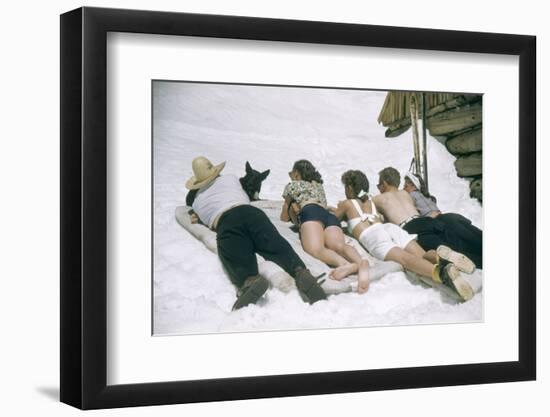 Skiers Sunbathing in Summer Fashions with Dog at Sun Valley Ski Resort, Idaho, April 22, 1947-George Silk-Framed Photographic Print