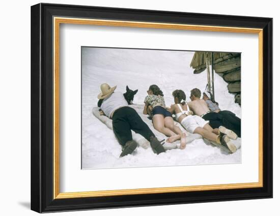 Skiers Sunbathing in Summer Fashions with Dog at Sun Valley Ski Resort, Idaho, April 22, 1947-George Silk-Framed Photographic Print