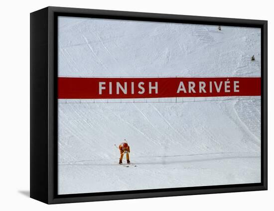 Skiier Arrives at the Finish Line-Paul Sutton-Framed Premier Image Canvas