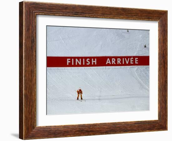 Skiier Arrives at the Finish Line-Paul Sutton-Framed Photographic Print