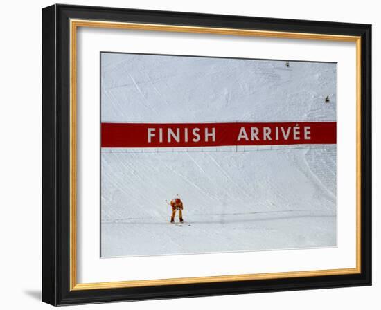 Skiier Arrives at the Finish Line-Paul Sutton-Framed Photographic Print