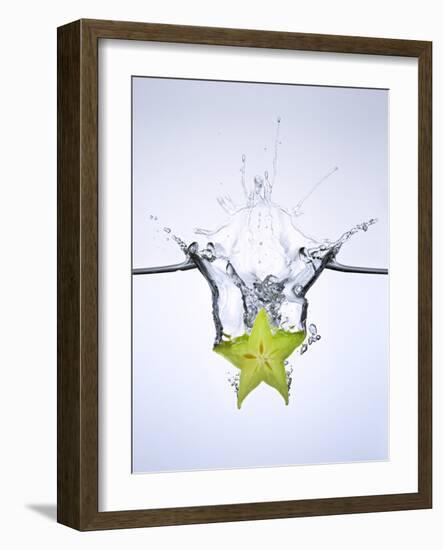 Slice of Carambola Falling into Water-Kröger & Gross-Framed Photographic Print