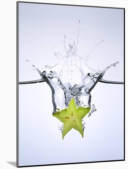 Slice of Carambola Falling into Water-Kröger & Gross-Mounted Photographic Print