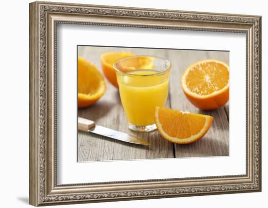 Sliced Oranges and Glass with Fresh Orange Juice-Jana Ihle-Framed Photographic Print