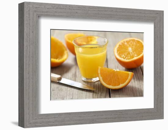 Sliced Oranges and Glass with Fresh Orange Juice-Jana Ihle-Framed Photographic Print