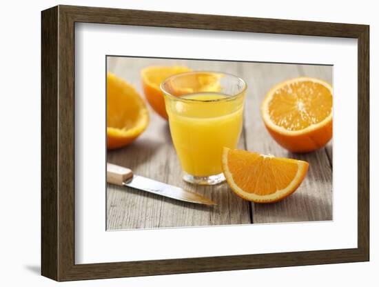 Sliced Oranges and Glass with Fresh Orange Juice-Jana Ihle-Framed Photographic Print