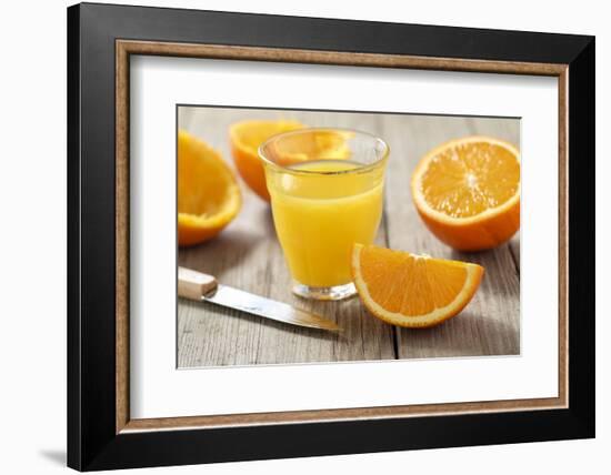 Sliced Oranges and Glass with Fresh Orange Juice-Jana Ihle-Framed Photographic Print