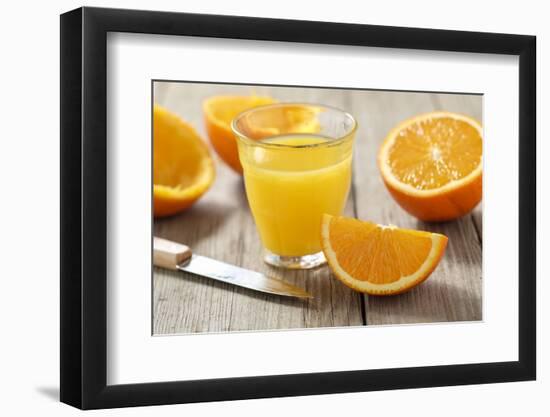 Sliced Oranges and Glass with Fresh Orange Juice-Jana Ihle-Framed Photographic Print