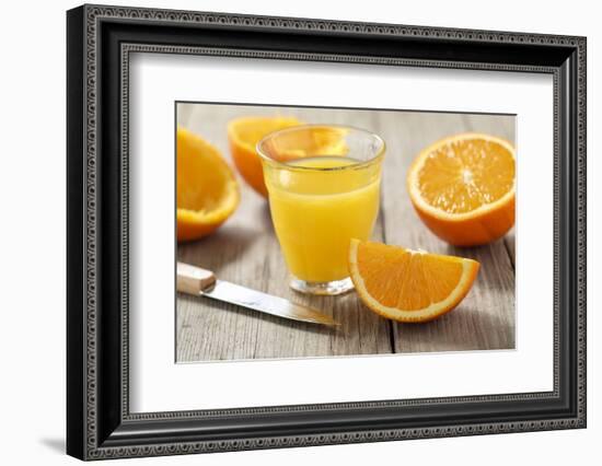 Sliced Oranges and Glass with Fresh Orange Juice-Jana Ihle-Framed Photographic Print